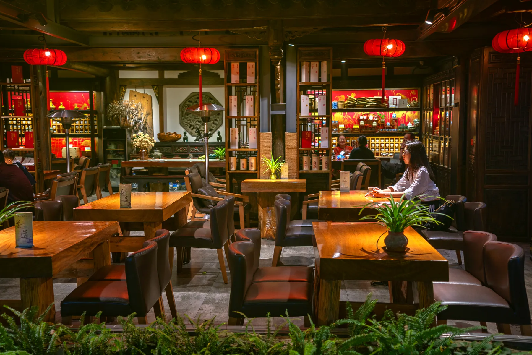 Tea house hall with red lanterns and carved wooden screens